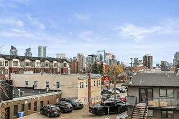 A parking lot with cars and a building in the background.